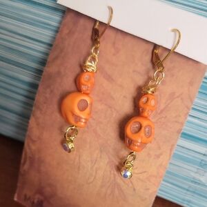 Gold-Tone Orange Skull Drop Earrings with Crystal Accent